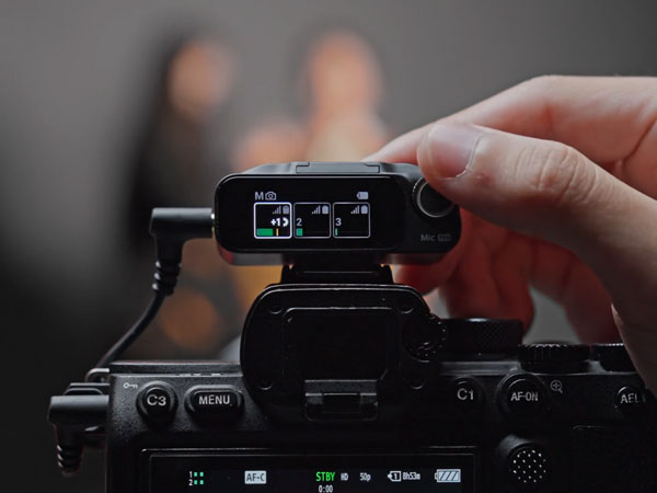 someone making adjustments using the mic pro receiver