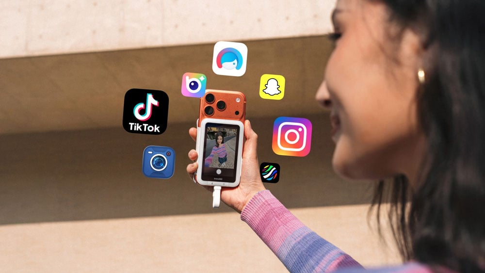 someone taking a selfie using the Insta360 Snap with various social media app logos surrounding it