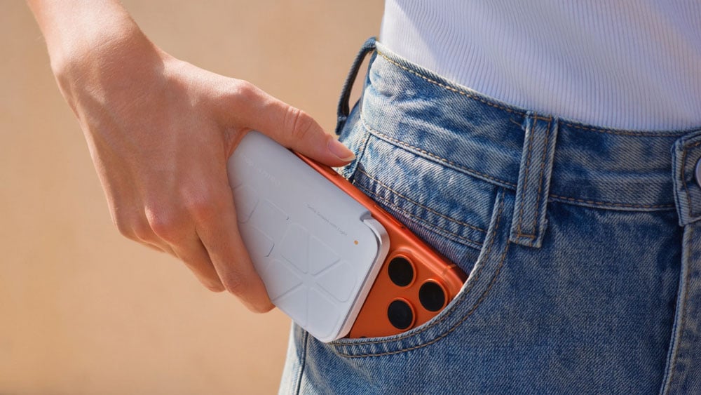 someone putting the Insta360 Snap connected to a phoen in their pocket