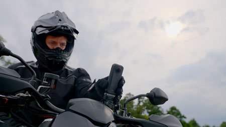 insta 360 camera being mounted to a motorbike