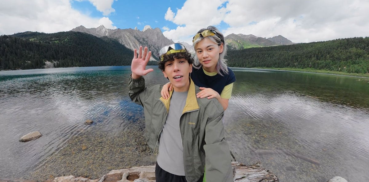 two people posing by a scenic mountain lake taken using the insta360 x6