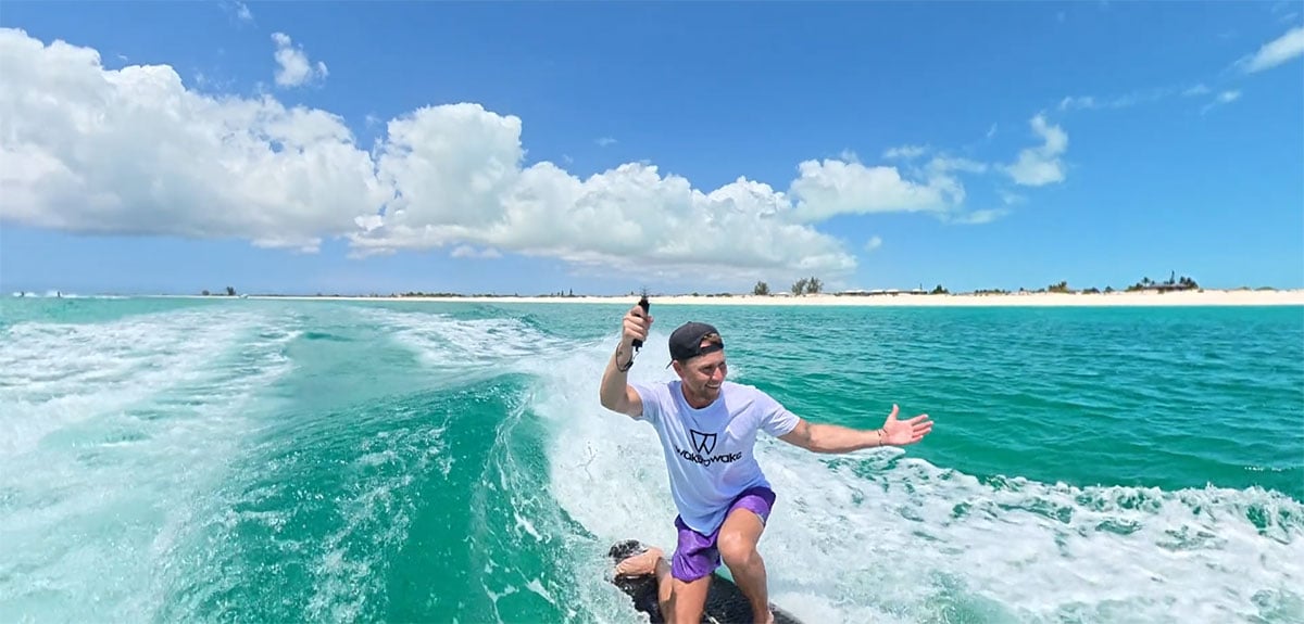 bullet time sample image of a man wakesurfing in clear turquoise coastal waters