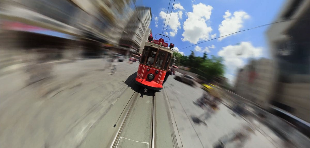red nostalgic tram on İstiklal Avenue in Istanbul during a timeshift shot