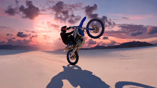 edited image of a dirt bike rider performing a wheelie