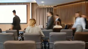 people walking into a corporate meeting room