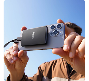 Person capturing video with Apple iPhone 15 Pro Max and Lexar Armor 700 SSD