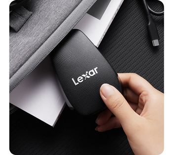 person putting lexar cfexpress type b card reader into laptop sleeves
