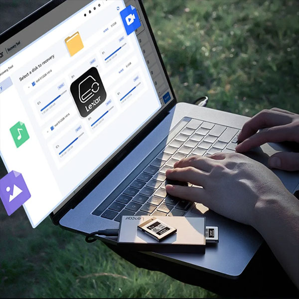 a person using a laptop connected to a Lexar Professional Workflow CFexpress 4.0 Type B Card Reader alongside a memory card