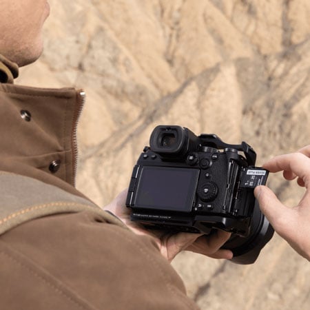sdxc card being inserted into a camera