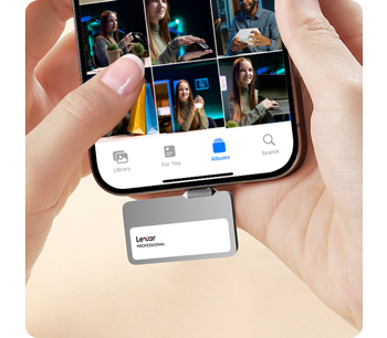 Person holding smartphone transfering footage to lexar go portable ssd