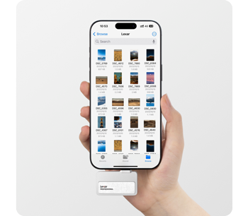 Person holding smartphone transfering footage to lexar go portable ssd