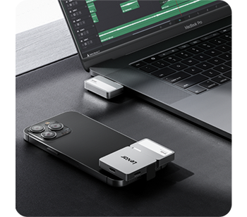 person typing on apple macbook with Lexar Go Portable SSD connected 