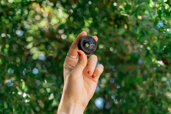 a hand holding up the fisheye lens