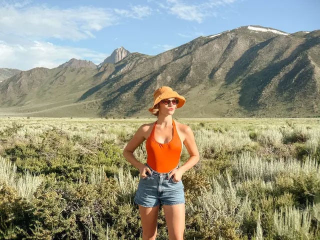 sample image of a woman stood infront of a mountain range using the iphone 14 pro 1x camera and mobile lens