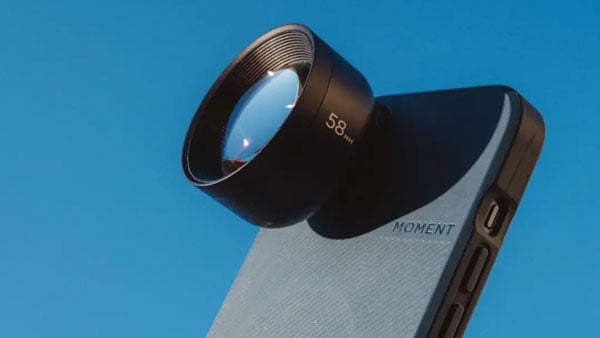 angled view of the tele mobile lens connected to a smartphone on a blue background