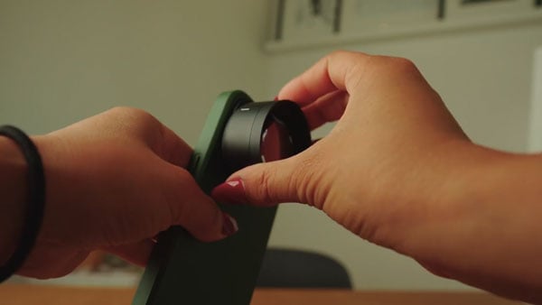 tele mobile lens being attached to a smartphone