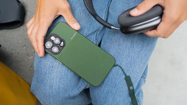 someone holding a phone on their lap in a moment case
