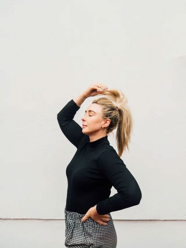 sample image of a woman stood in front of a white wall