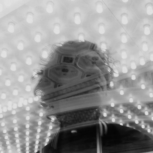 sample black and white image of a man through glass