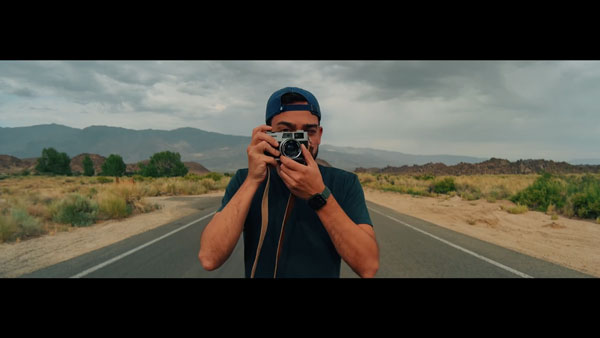 example image of someone taking a photo with a camera on a desert road