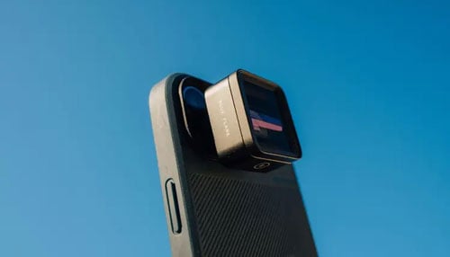 mobil lens attached to a phone using the moment case on a blue background