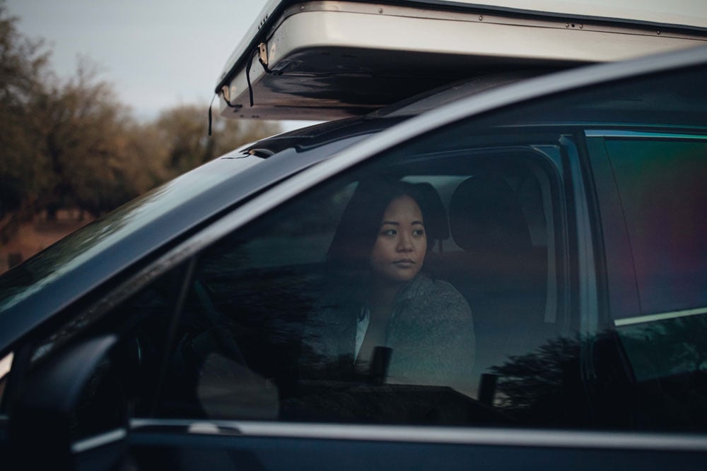sample image of a woman sat in a car using the moment antiglare filter