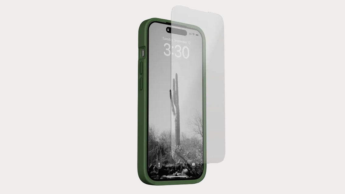 screen protector being attached to a phone in the moment phone case
