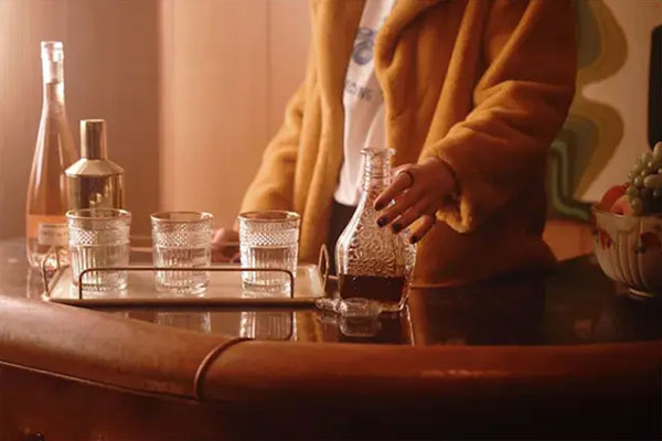 sample image of someone reaching for a bottle on a tray taken with the cinebloom filter