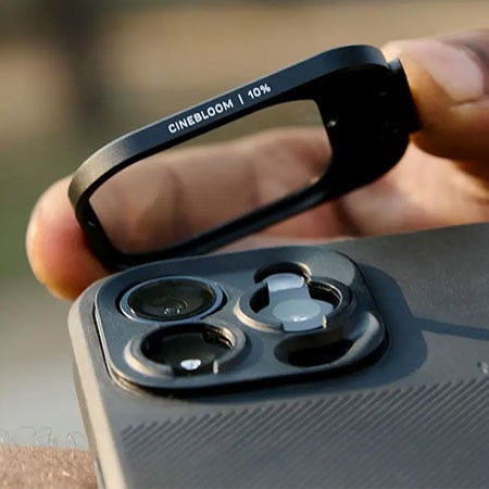 close up of a CineClear UV QuickLock Filter being attached to a phone
