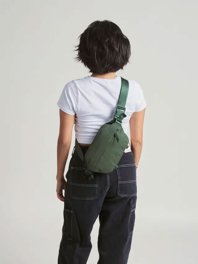 someone wearing the sling bag across their back