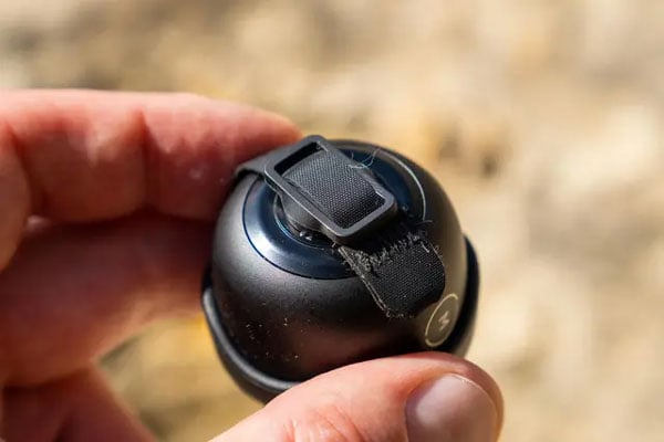 close up of someone holding the back of the moment lens cap attached to a lens