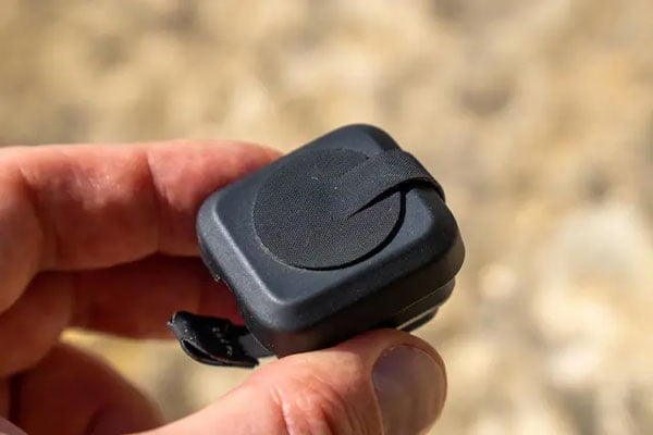close up of someone holding the front of the moment lens cap attached to a lens