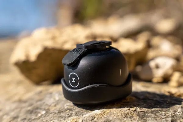 moment lens cap attached to a lens thats sitting on a rock
