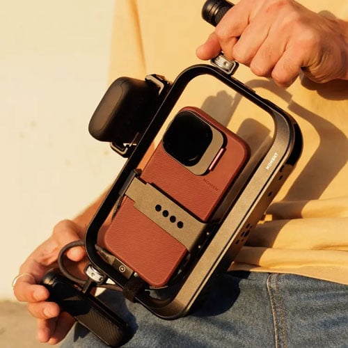 Apple iPhone 17 Pro mounted in Moment SuperCage being used by videographer