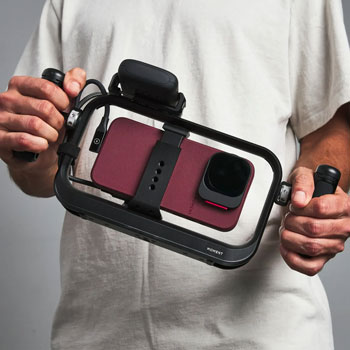 filmmaker holding Moment SuperCage with Universal Grip Handles