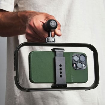 Videographer using Moment BaseCage with iPhone 17 pro with Universal Grip Top Handle