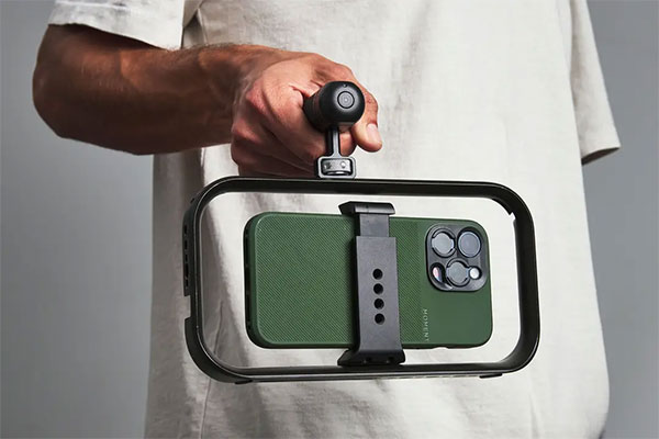 someone holding a phone in a moment cage using the universal mobile grip