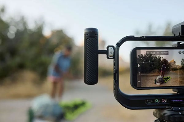 close up of the moment universal mobile grip attached to a cage