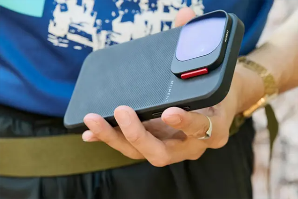 someone holding a phone in a moment case with the vnd filter attached