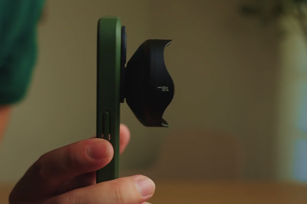 someone holding a smartphone with the moment mobile lens attached