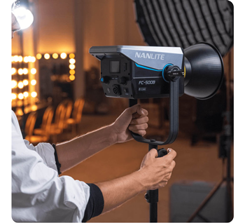 person adjusting Nanlite FC-500B on light stand in studio