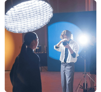 photographer shooting images of model in photography studio with nanlite FC-500B