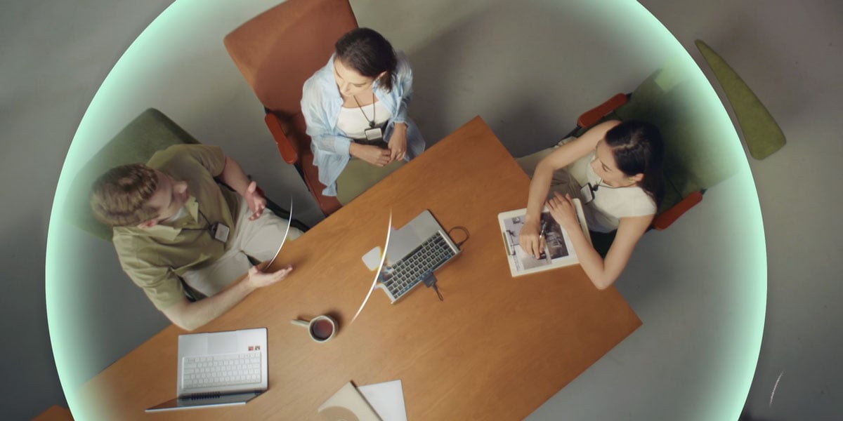 top down view of 3 people having a meeting using the obsbot meet flip