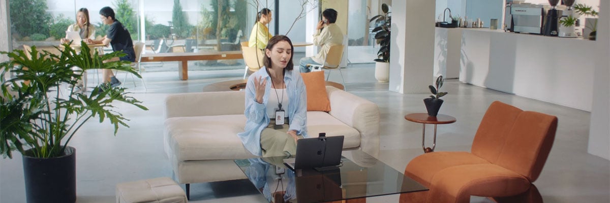 someone using the obsbot meet flip for a meeting in a busy reception area
