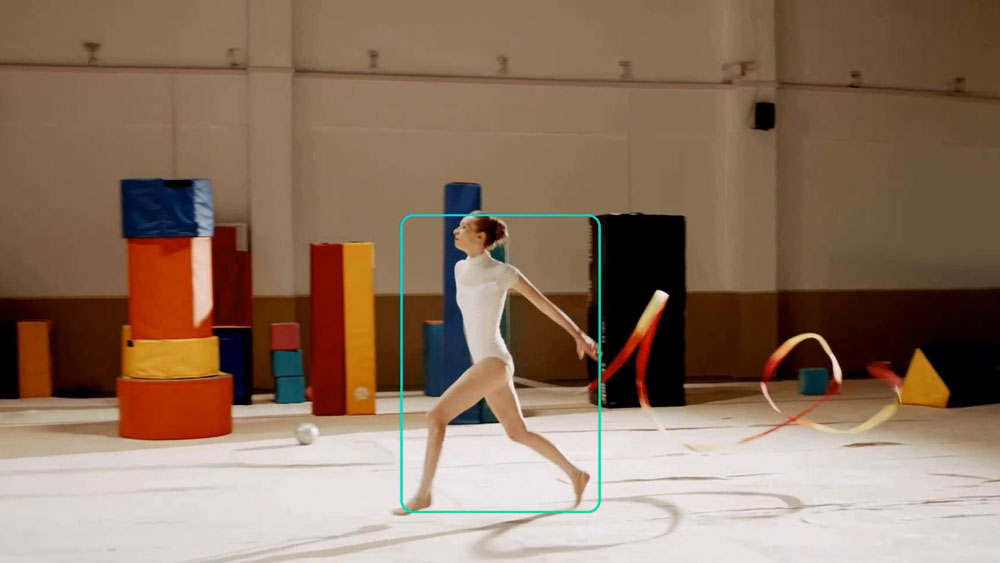 a dancer with a yellow and red ribbon being tracked by the obsbot ptz camera
