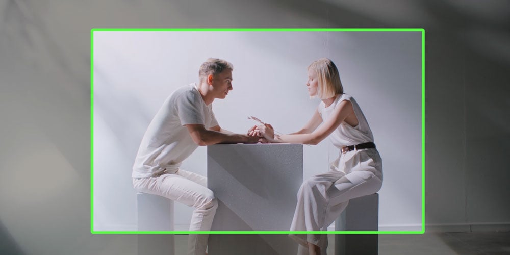 ai auto framing of two people sat at a table