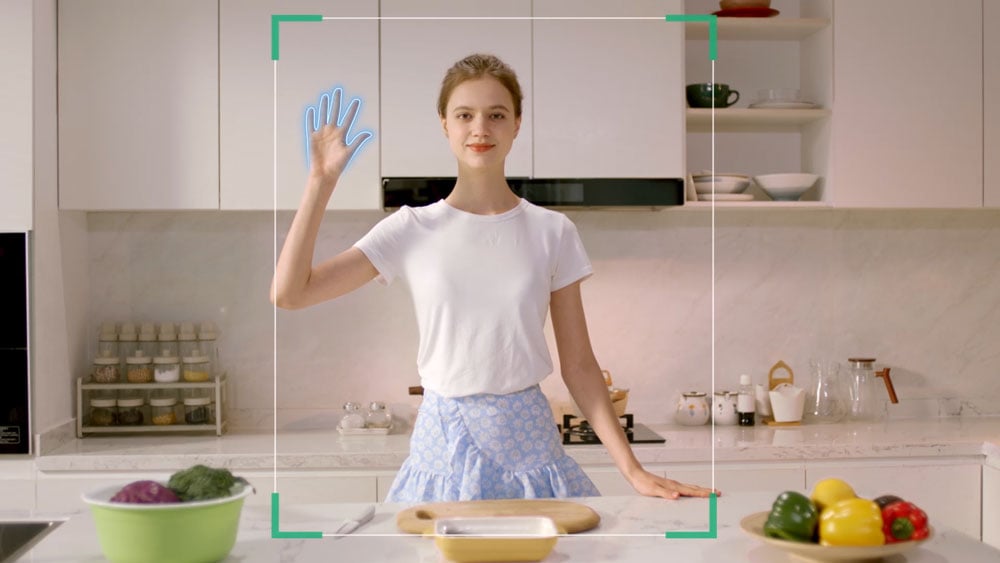 a woman in a kitchen using the lock gesture