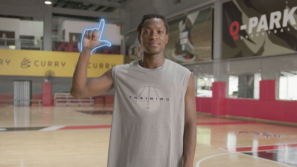 a man on a basketball court using the zoom in/out gesture