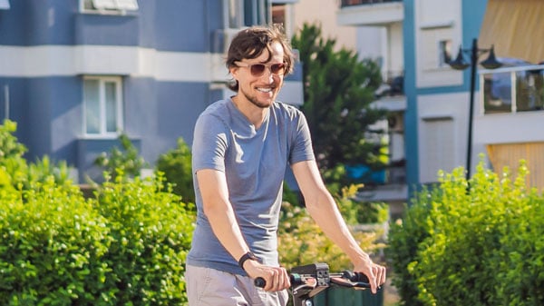 half body zoom of a man on a scooter