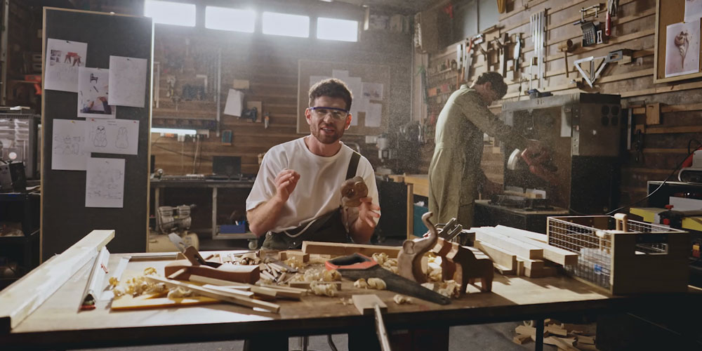 someone using the obsbot tiny in a busy wood working studio